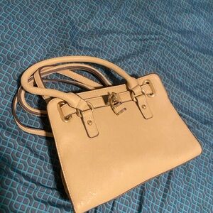 The Charmin Charlie Crossbody Gold Lock Accent Cream Handbag